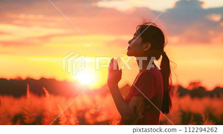 Stylish Woman in Yoga Pose Praying at Sunset Stylish Woman in Yoga Pose Praying at Sunset 112294262