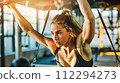 Woman Exercising in a Modern Gym 112294273