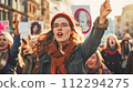 Woman Holding Signs during Gender Inequality Protest 112294275
