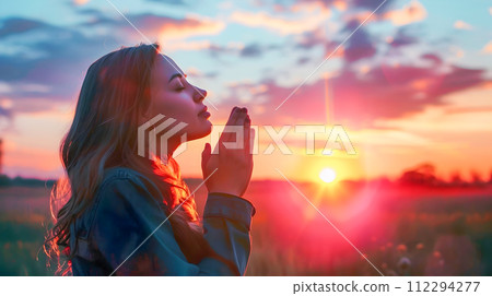 Woman in Field at Sunset Praying with Faith and Hope Woman in Field at Sunset Praying with Faith and Hope 112294277