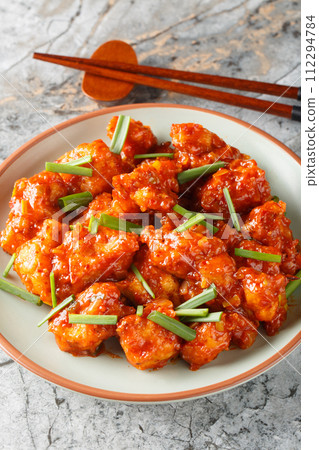 Gobi Manchurian pairs crispy cauliflower with a sweet, tangy Indo-Chinese sauce closeup on the plate. Vertical Gobi Manchurian pairs crispy cauliflower with a sweet, tangy Indo-Chinese sauce closeup on the plate. Vertical 112294784