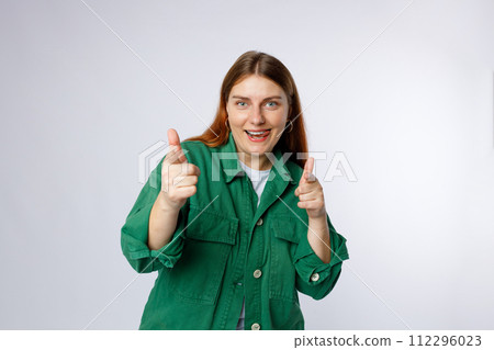 Young smiling happy fun woman point index finger camera on you say do it motivate isolated on white background, studio portrait. Looking at the camera and smiling 112296023