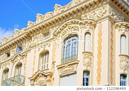 Windows France. Nice. Classic old wooden windows with shutters in a public place on a city street or in an urban environment. Windows France. Nice. Classic old wooden windows with shutters in a public place on a city street or in an urban environment. 112296469