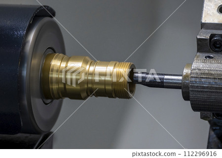The CNC lathe machine bore cutting the brass material shaft parts. The CNC lathe machine bore cutting the brass material shaft parts. 112296916