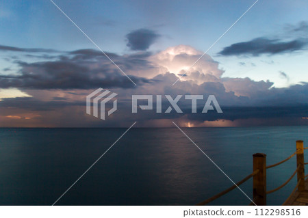 Thunderstorm with lightning in the sky over the pier in the early morning 112298516