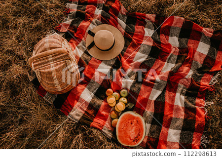 Travel blanket checkered red plaid on grass in summer on sunny day for picnic. 112298613