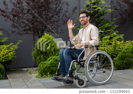 Young disabled man in eyeglasses waving his hand Young disabled man in eyeglasses waving his hand 112299003