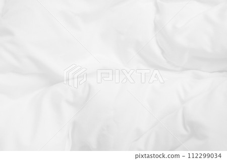 Close up top view of white bedding sheet and wrinkle messy blanket in bedroom after wake up in the morning. 112299034