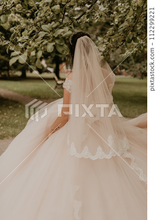 Caucasian young woman bride spinning whirls dancing posing moving at nature Caucasian young woman bride spinning whirls dancing posing moving at nature 112299221
