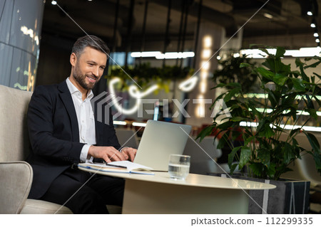 Elegant businessman working and looking excited 112299335