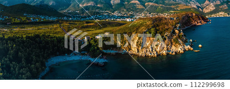 Aerial top evening view drone above Adriatic sea Montenegro. panoramic sunny marine mountain sunset Aerial top evening view drone above Adriatic sea Montenegro. panoramic sunny marine mountain sunset 112299698