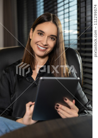 Cute young business woman with a tablet in hands Cute young business woman with a tablet in hands 112299874
