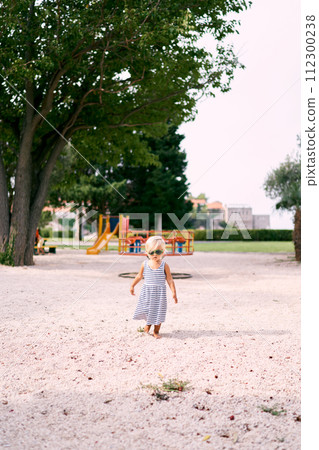 Little girl in sunglasses walks barefoot on the playground. High quality photo Little girl in sunglasses walks barefoot on the playground. High quality photo 112300238