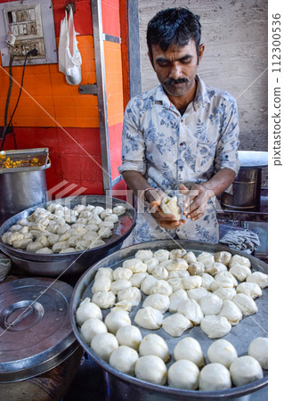 Seller preparing Traditional Cardamom Kachori, street food in markets and bazaar 112300536