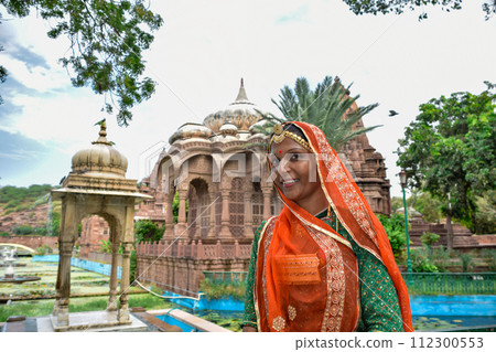 Indian Woman with beautiful face posing with textiles in background Indian Woman with beautiful face posing with textiles in background 112300553