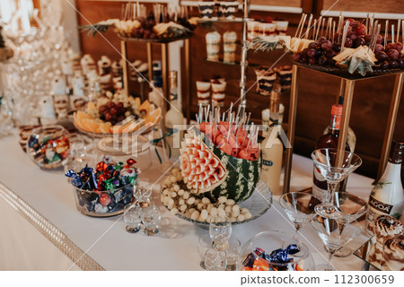 stylish desserts with strawberry, candy bar with sweets at luxury wedding reception. 112300659