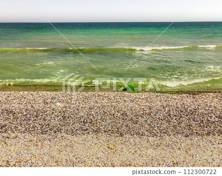 Sea green aquamarine waves line sunny seashell beach. wave ocean foam. 112300722