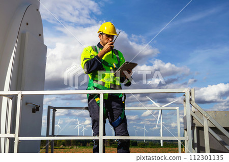 engineers are discussing maintenance of wind turbines. Clean energy. Alternative energy concept engineers are discussing maintenance of wind turbines. Clean energy. Alternative energy concept 112301135