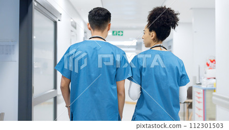 Doctors, man and woman in hallway, talking and partnership with back, discussion and ideas in clinic. Medic, nurse or surgeon teamwork with planning, brainstorming or problem solving in hospital 112301503