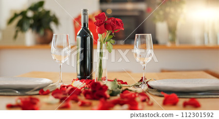 Wine, flowers and romance on valentines day for celebration of love, anniversary or honeymoon in still life. Glass, dinner and elegant date in dining room of home for event, milestone or occasion Wine, flowers and romance on valentines day for celebration of love, anniversary or honeymoon in still life. Glass, dinner and elegant date in dining room of home for event, milestone or occasion 112301592