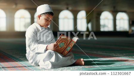 Islam, boy in mosque reading Quran for learning mindfulness and gratitude in faith with kids prayer. Worship, religion and Muslim student in holy temple praise with book, spiritual teaching and study 112301667