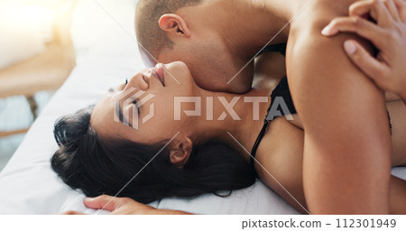 Couple, kiss in bed and sex for intimacy, people bond for relationship or passion with love and trust at home. Foreplay, lust and seduction on Valentines day with sexual moment and romance in bedroom Couple, kiss in bed and sex for intimacy, people bond for relationship or passion with love and trust at home. Foreplay, lust and seduction on Valentines day with sexual moment and romance in bedroom 112301949