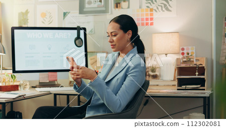Phone, happy and businesswoman in the office typing a text message on social media or the internet. Smile, technology and professional female creative designer scroll on cellphone in the workplace. Phone, happy and businesswoman in the office typing a text message on social media or the internet. Smile, technology and professional female creative designer scroll on cellphone in the workplace. 112302081