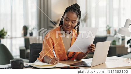 Black woman in home office, documents and laptop for research in remote work, ideas and thinking. Happy girl at desk with computer, writing notes and online search in house for freelance networking. 112302190