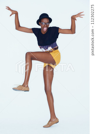 Funny, portrait and black woman with fashion, goofy and cheerful girl on white studio background. African person, hipster or model with glasses or pose with comedy, excited and casual outfit with joy Funny, portrait and black woman with fashion, goofy and cheerful girl on white studio background. African person, hipster or model with glasses or pose with comedy, excited and casual outfit with joy 112302275