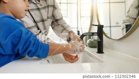Woman, child and washing hands in bathroom, cleaning to prevent germs and dirt in home with soap, water and hygiene. Kid, mom and hand wash, teaching, learning and clean morning routine with family. 112302346