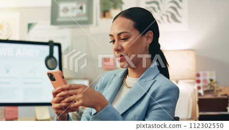 Phone, happy and businesswoman in the office typing a text message on social media or the internet. Smile, technology and professional female creative designer scroll on cellphone in the workplace. 112302550