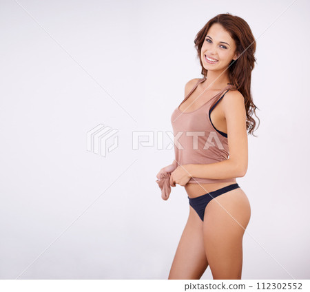 Portrait, body and happy woman in underwear in studio for wellness, confidence or care on grey background. Face, smile or model in lingerie with results satisfaction from diet, detox or glowing skin 112302552