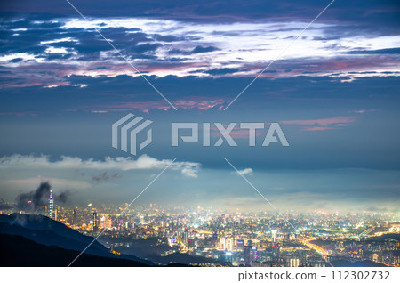 Rolling clouds and city lights enrich the night scene. Rolling clouds and city lights enrich the night scene. 112302732