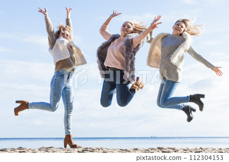 Three women jumping 112304153