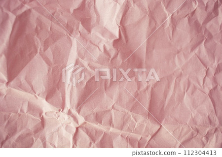 Crumpled craft paper background. Texture of pink packaging crumpled paper, top view, copy space Crumpled craft paper background. Texture of pink packaging crumpled paper, top view, copy space 112304413
