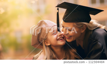 Happy dark-skinned, black, African-American mother hugging her student daughter in a cap, graduate cap near an educational institution. Happy dark-skinned, black, African-American mother hugging her student daughter in a cap, graduate cap near an educational institution. 112304484