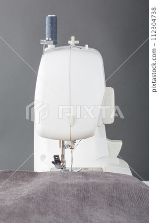 Sewing machine, stitching fabrics, needle in a round plan Sewing machine, stitching fabrics, needle in a round plan 112304738