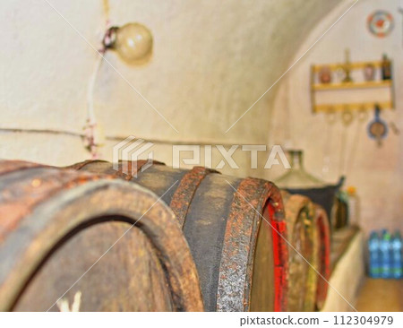 Wines fermented in classic wooden barrels. Typical Moravian wine cellar, South Moravia, Czech Republic, Europe Wines fermented in classic wooden barrels. Typical Moravian wine cellar, South Moravia, Czech Republic, Europe 112304979