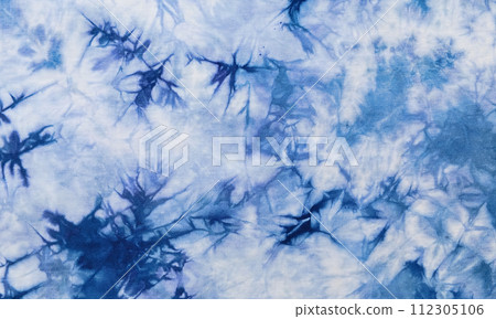 Close-up batik shirt with abstract indigo blue dye detail on white fabric cotton background on top-view Close-up batik shirt with abstract indigo blue dye detail on white fabric cotton background on top-view 112305106