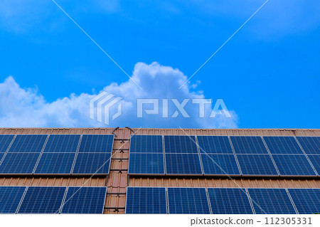 Close-up solar panels mounted on the roof on modern building for receive energy from sunlight for converted to electrical energy for use with appliances electricity on blue sky, renewable energy 112305331
