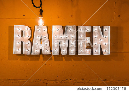 Neon lights that have the word ramen written on an orange background. 112305456