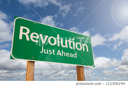 Revolution Just Ahead Green Road Sign Over Clouds and Blue Sky. Revolution Just Ahead Green Road Sign Over Clouds and Blue Sky. 112306244