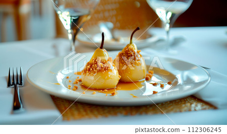 Paleo style dessert poached pear dessert pashot. Pear caramelized in syrup on a wooden plate Paleo style dessert poached pear dessert pashot. Pear caramelized in syrup on a wooden plate 112306245