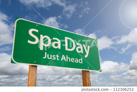 Spa Day Just Ahead Green Road Sign Over Clouds and Blue Sky. 112306252
