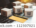 Shopping online. Credit card and cardboard box with a shopping cart logo on laptop keyboard. Shopping service on The online web. offers home delivery 112307021