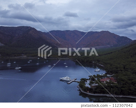 Yachts in the bay aerial view from drone. Blue sea water. Mediterranean yacht port with sailing boats. Yachting concept. 112307042