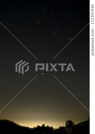 Winter stars rising in the twilight. Sirius and Orion in golden hour 112307436