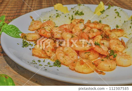 Grilled prawns and cooked rice with slices of lemon and chopped basil. Food photography. Bio healthy recipe Grilled prawns and cooked rice with slices of lemon and chopped basil. Food photography. Bio healthy recipe 112307585