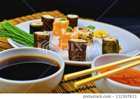 Fresh and delicious sushi Japanese food. Image of Japanese food. Sushi rolls served on a plate in a restaurant Fresh and delicious sushi Japanese food. Image of Japanese food. Sushi rolls served on a plate in a restaurant 112307613