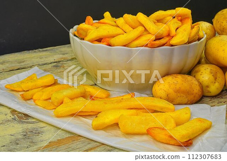 Baked fried potatoes. Potatoes and french fries Baked fried potatoes. Potatoes and french fries 112307683